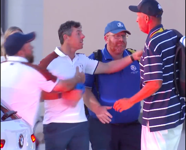 <p>Rory McIlroy gestures furiously in discussion with US caddie Jim ‘Bones’ Mackay</p>